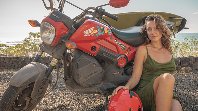 Attractive woman with scooter in Tamarindo beach