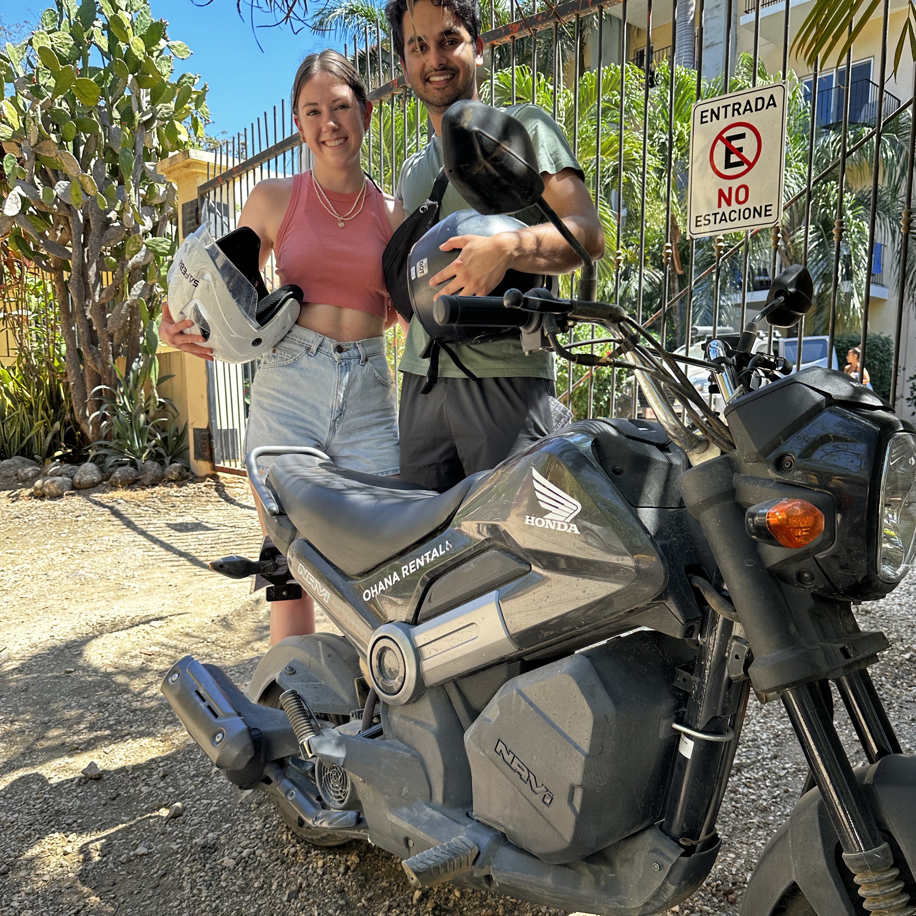 Ohana Rental Client Testimonial - Rujul Kumar standing next to a Honda Navi Scooter at a beach in Tamarindo