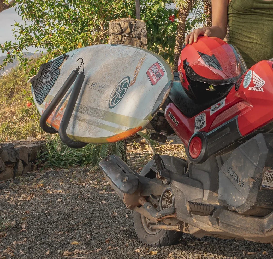 Red Honda scooter with surfboard rack, ready for Tamarindo beach adventures